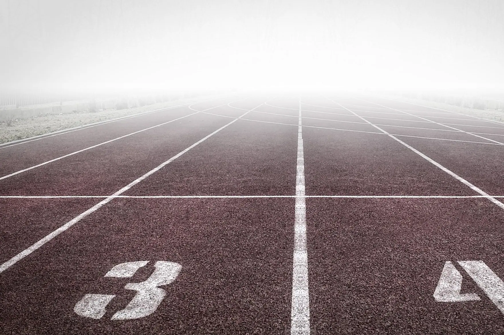 Running track, numbers and fog